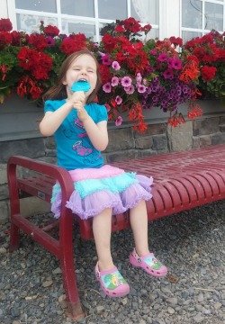 little girl eating a popsicle