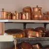 copper pots on a shelf