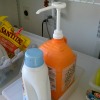 dispensing Tide laundry detergent