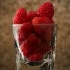 raspberries in glass cup