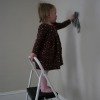 little girl cleaning wall