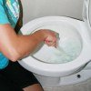 woman cleaning toilet