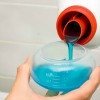 pouring liquid laundry detergent