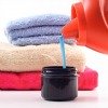 pouring laundry detergent into cap