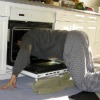 man cleaning oven