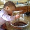 child stirring pudding